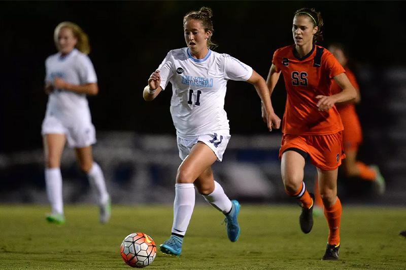 Darcy McFarlane dribbling the ball during a UNC-Syracuse women's soccer game.